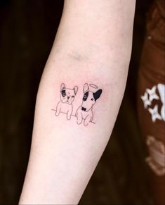 two small dogs tattoo on the arm