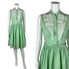 Vintage 1950s Mint Green Dress Women's Extra Small Sleeveless Ruffle Bib Belted Shirtdress You'll look as sweet as a scoop of mint ice cream in this darling 1950s shirt dress! This vintage beauty is a lovely shade of mint green with a white ruffle detail on the bodice, rhinestone buttons and a fitted waist with matching belt. Vintage dress zips up the side with a metal zipper. LABEL: - FABRIC: feels like cotton  MARKED VINTAGE SIZE: - SHOULDERS: 13.5" SHOULDER TO WAIST: 14.5" BUST: 35" WAIST: 26 1950s Style Sleeveless Summer Vintage Dress, Summer Sleeveless Vintage 1950s Style Dress, Green Sleeveless Retro Vintage Dress, Summer Green Vintage Dress With Ruffles, 1950s Style Summer Dress With Ruffles, 1950s Style Ruffled Summer Dress, Green Vintage Style Dress For Summer, Green Vintage Dress For Summer, Retro Sleeveless Vintage Dress With Ruffles