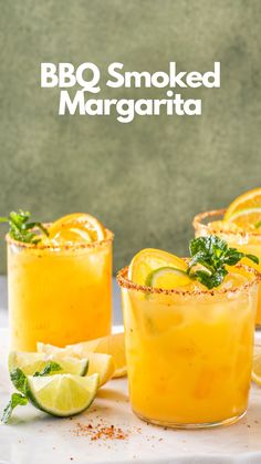 two glasses filled with orange juice and garnished with mint