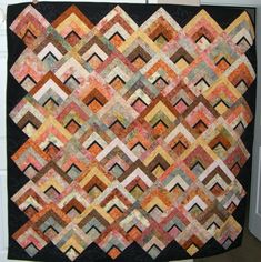 an old quilt hanging on the wall