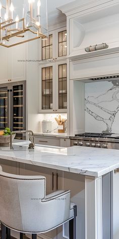 a large kitchen with an island and bar stools in front of the countertop