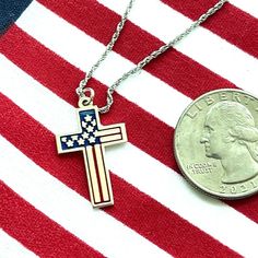 Show your patriotism with this stunning 925 sterling silver cross necklace. Featuring a finely detailed American flag engraving filled with vibrant enamel, this piece is both elegant and meaningful. The slender rope chain complements the cross perfectly, adding a touch of sophistication to your look. Whether you're wearing it daily or for special occasions, this necklace is sure to become a cherished addition to your jewelry collection. Features: Material: 925 Sterling Silver Design: Cross with American Flag Engraving Enamel Inlay: Red, White, and Blue Chain Type: Slender Rope Chain Chain Length: 18 inches plus 2 inch to make it 20 inch total. Dimensions: Cross Pendant: 1.2 inches (height) x 0.8 inches (width) Proudly made in the U.S.A. Packaging: Comes in a beautiful gift box, ready for g American Flag Jewelry For Independence Day Gift, Patriotic American Flag Jewelry Gift, Patriotic Silver Jewelry For Independence Day, Silver Cross Necklace, Sterling Silver Cross Necklace, Silver Design, Sterling Silver Cross, Silver Enamel, Silver Cross