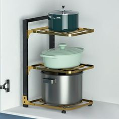 three pots and pans are stacked on the shelf in front of each other,