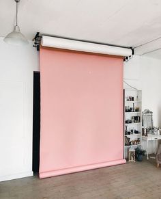 a pink roller up blind in a living room