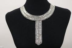 a black mannequin with a silver necklace on it