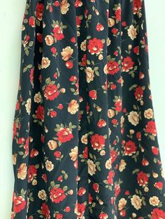 Vintage black floral skirt Approximate Size: 13 W; 33 L Black Floral Print Skirt For Summer, Black Floral Print Maxi Skirt For Spring, Summer Black Maxi Skirt With Floral Print, Black Floral Print Skirt, Black Floral Print Mini Skirt, Black Floral Print Flowy Skirt, Black Flowy Floral Skirt, Black Skirted Bottoms With Floral Print, Chic Black Floral Print Maxi Skirt