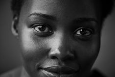 a black and white photo of a woman's face with her eyes wide open