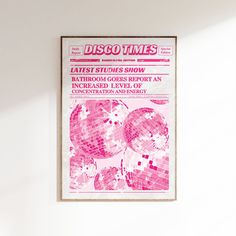 a pink disco ball poster hanging on the wall