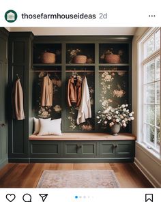 a room with green cabinets and flowers on the wall