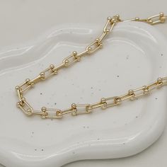 The Ryker Necklace, a timeless piece, embodies luxury and sophistication. Crafted from 18K gold filled materials, this 8mm bead link chain features a lustrous finish and a versatile 18-inch length with a 2" extender. Its refined elegance makes it a must-have for those who appreciate quality craftsmanship and style. Perfect for any occasion, it's sure to make a statement. 18" with 2" extension 18k gold filled demi-fine Luxury Link Chain Necklace Tarnish Resistant, Classic Gold-plated Paperclip Chain Necklace, Formal Gold Plated Necklace With Paperclip Chain, Formal Gold-plated Necklace With Paperclip Chain, Luxury Tarnish-resistant Oval Link Chain Necklace, Luxury Chunky Chain Oval Link Necklace, Luxury Chunky Chain Necklace With Oval Links, Luxury Oval Link Chunky Chain Necklace, Luxury Tarnish Resistant Chain Necklace With Rectangular Links