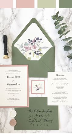 the wedding stationery is laid out on a marble countertop with greenery and flowers