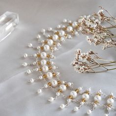 Experience the harmonious blend of natural beauty and timeless elegance with our Pearls and Crystals Symphony Necklace. Hand-crafted from freshwater pearls and crystals in various sizes, this exquisite choker-style necklace is the epitome of sophistication. The luminous natural pearls framed with golden Swarovski crystals, create a mesmerizing effect that will add a touch of glamour to any outfit, especially an off-shoulder dress or blouse. Ivory Sea Cultured Pearls Golden Swarovski Crystals Met Delicate White Pearl Drop Choker, Delicate White Pearl Choker, White Akoya Pearl Beaded Necklace With Pearl Drop, White Akoya Pearl Drop Beaded Necklace, Akoya Pearl Beaded Necklaces With Pearl Charm For Wedding, Akoya Pearl Charm Beaded Necklaces For Wedding, Wedding Akoya Pearl Beaded Necklaces With Pearl Charm, Delicate White Pearl Bracelet With Pendant, Wedding Akoya Pearl Beaded Necklace With Pearl Charm