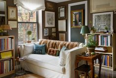 a living room filled with furniture and lots of books