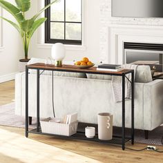 a living room with a couch, table and television on top of the tv stand