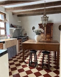 an old fashioned kitchen with checkered flooring