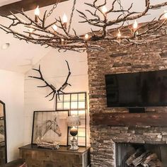 a living room filled with furniture and a fire place next to a tv mounted on a wall