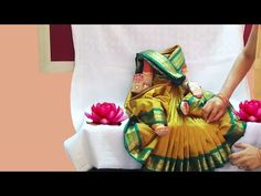 a woman sitting on top of a table next to flowers