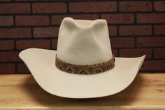 Inspired by the tall crown hat John Wayne wore in his last Western The Shootist (1976) Handmade to Order Crown: Front 6-1/4", Back: 6" Color: Bone (Also available in Granite) Brim: 4-1/2" raw w/slight upturn on sides Hatband: 1-1/4" snakeskin hatband Estimated delivery 8-12 weeks * Disclaimer: "The Shootist", is TM and © (or copyright) by Paramount Pictures. Any reproduction, duplication or distribution of these materials in any form is prohibited. This web site, its operators, including, but no Tall Crown, Los Angeles Street, Color Bone, Crown Hat, Western Hats, John Wayne, Paramount Pictures, 12 Weeks, Hat Band