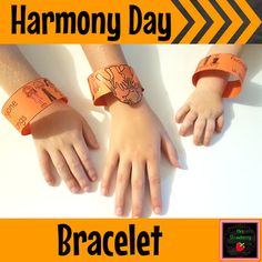 three children's hands with wristbands on them and the words harmony day