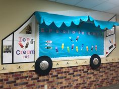 a bulletin board with ice cream on it and some paper decorations hanging from the wall