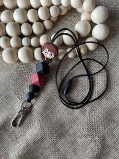 Check out this adorable little HP lookalike lanyard!  Made with silicone beads strung on nylon cording.  The clasp is plastic breakaway.  The lanyard measures between 21 and 22 inches long.  Encourage a love of reading wearing this favorite little guy! Adjustable Black Lanyards For Personal Use, Adjustable Lanyard With Lobster Clasp For Personal Use, Adjustable Lanyard With Lobster Clasp For Gift, Adjustable Black Lanyard For School, Adjustable Black Lanyards For School, Adjustable Black Lanyard For Everyday Use, Adjustable Red Lanyard As Gift, Cute Adjustable Lanyard As Gift, Cute Adjustable Lanyards For Gifts