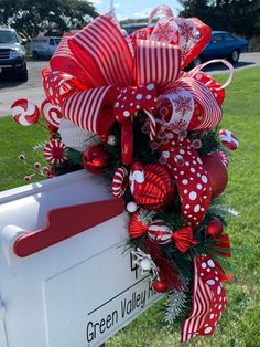 a mailbox decorated with red and white bows