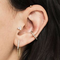 a close up of a person's ear with two different types of piercings