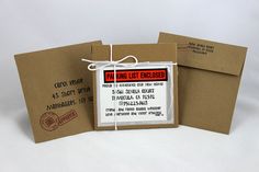 two brown envelopes with red and white labels on them