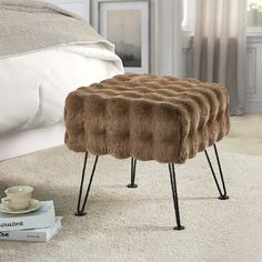 a foot stool sitting on top of a carpeted floor next to a white bed