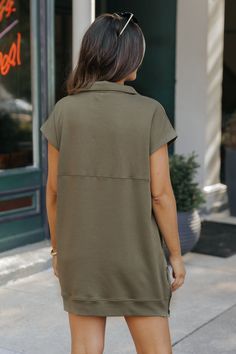 Meet your new go-to dress! Made from a soft and comfortable blend of cotton, polyester, and spandex, this Olive Half Zip Short Sleeve Mini Dress offers convenience and style with its half zip front, split hem, and side pockets. Perfect for any occasion, this mini dress is sure to elevate your wardrobe! Casual Fall Dress With Curved Hem, Casual Mini Dress With Side Zipper, Casual Dresses With Side Zipper For Work, Casual Workwear Dress With Curved Hem, Short Sleeve Utility Dress, Casual Dark Wash Button-up Mini Dress, Casual Medium Wash Button-up Mini Dress, Summer Medium Wash Button-up Mini Dress, Green Button-up Mini Dress With Button Closure