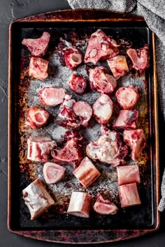 raw meats on a baking sheet ready to be cooked in the oven for cooking