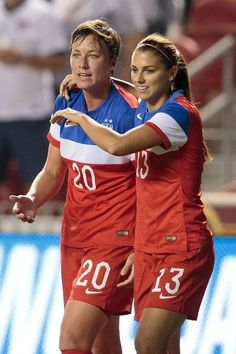 two female soccer players are hugging each other