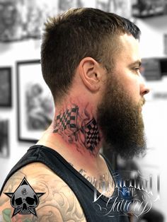 a man with tattoos on his neck and chest