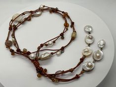 "A boho pearl and leather tassel necklace featuring beautiful 7 oval Mabe (pronounced \"MA-BAY\") freshwater pearls. Mabe pearls are also known as blister pearls which are hemispherical (only 1/2 pearl) beneath a Mother of Pearl shell coating.  The Mother of Pearl has been made into beautiful oval beads. They are absolutely stunning. I selected a sienna brown and copper color leather duo to create the neck area of this necklace. In addition to the Mabe pearls I have more freshwater baroque pearl Adjustable Bohemian Pearl Necklace With Charm, Bohemian Adjustable Pearl Necklace With Pearl Charm, Bohemian Adjustable Pearl Necklace With Charm, Adjustable Bohemian Pearl Drop Necklace, Bohemian Adjustable Pearl Drop Necklace, Adjustable Multi-strand Bohemian Pearl Necklace, Adjustable Bohemian Multi-strand Pearl Necklace, Mabe Pearl, Oval Beads