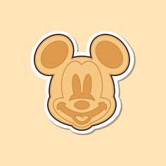 a cartoon mouse head sticker on a beige background