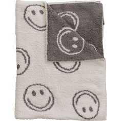 two towels with smiley faces on them, one is grey and the other is white