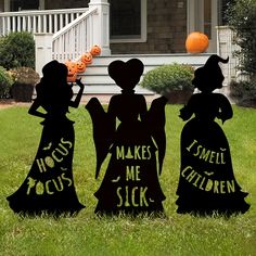 three halloween yard decorations in front of a house