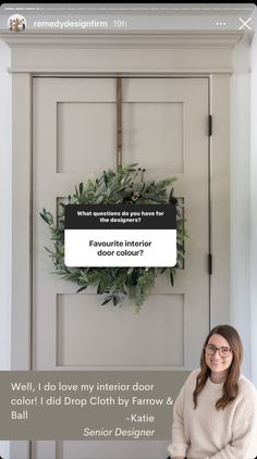 a woman sitting in front of a white door