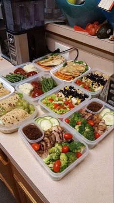 a bunch of trays filled with different types of food