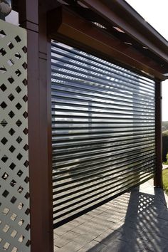 an outdoor area with a large metal door and wooden slats on the side of it