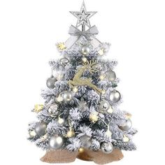 a white christmas tree with silver and gold ornaments on it's base, surrounded by star decorations