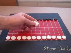 a person is playing a board game with marshmallows on the top and bottom