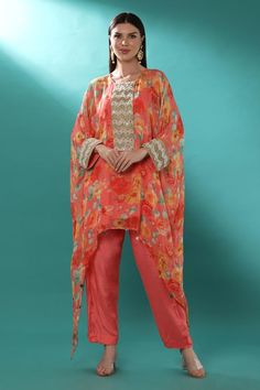 Pink georgette kaftan with floral print and badla, pearls and cutdana embroidered placket and cuffs. Comes with shantoon pant and an inner.
Components: 3
Pattern: Printed, Embroidered
Type Of Work: Floral, Badla, Pearls, Cutdana
Neckline: Round
Sleeve Type: Kaftan : Flared Sleeves, Inner : Sleeveless
Fabric: Shantoon, Kaftan : Georgette, Lining : Shantoon
Color: Pink
Other Details: 
Attached lining
Length :
Kaftan : 30 inches (Front) and 54 inches (Side)
Pant : 38 inches
Product Weight : 1 Kg
Oc Georgette Long Sleeve Pant Set With Dupatta, Long Sleeve Georgette Pant Set With Dupatta, Resham Embroidered Straight Kurta Pant Set In Georgette, Embroidered Georgette Pant Set For Eid, Eid Georgette Pant Set With Dabka Work, Straight Kurta Pant Set With Resham Embroidery, Traditional Georgette Pant Set With Dabka Work, Designer Semi-stitched Georgette Pant Set, Bollywood Style Festive Pant Set With Floral Print