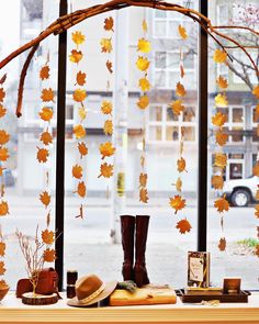 an instagram page with autumn leaves and boots on the table in front of a window