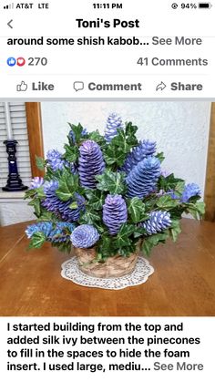 a vase filled with blue flowers on top of a wooden table