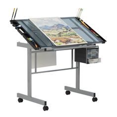 a drawing table with an easel on it and two pencils in the drawer