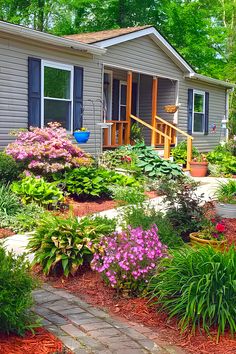 a house with flowers in the front yard