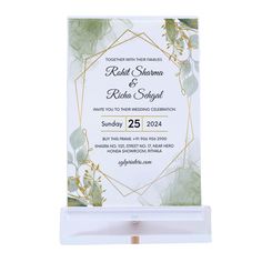 a white and gold wedding card holder with greenery on the front, featuring an elegant design