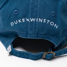 Our classic, signature baseball cap embroidered with "Nappin' Bulldogs" embroidery on the front & "Duke & Winston" on the back.Product Details • 100% Cotton Twill• Enzyme Washed• Antique Brass Side Buckle• Embroidered in the U.S.A Cotton Six-panel Hat For College, Cotton Dad Hat With Embroidered Logo For College, Vintage Blue Baseball Cap With Embroidered Logo, Collegiate Cotton Baseball Cap With Flat Bill, Blue Cotton Snapback Hat With Embroidered Logo, Curved Brim Dad Hat With Embroidered Logo For College, Cotton Six-panel Baseball Cap For College, College Dad Hat With Embroidered Logo, Adjustable Blue Baseball Cap For College