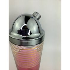 a silver and pink vase with a metal lid